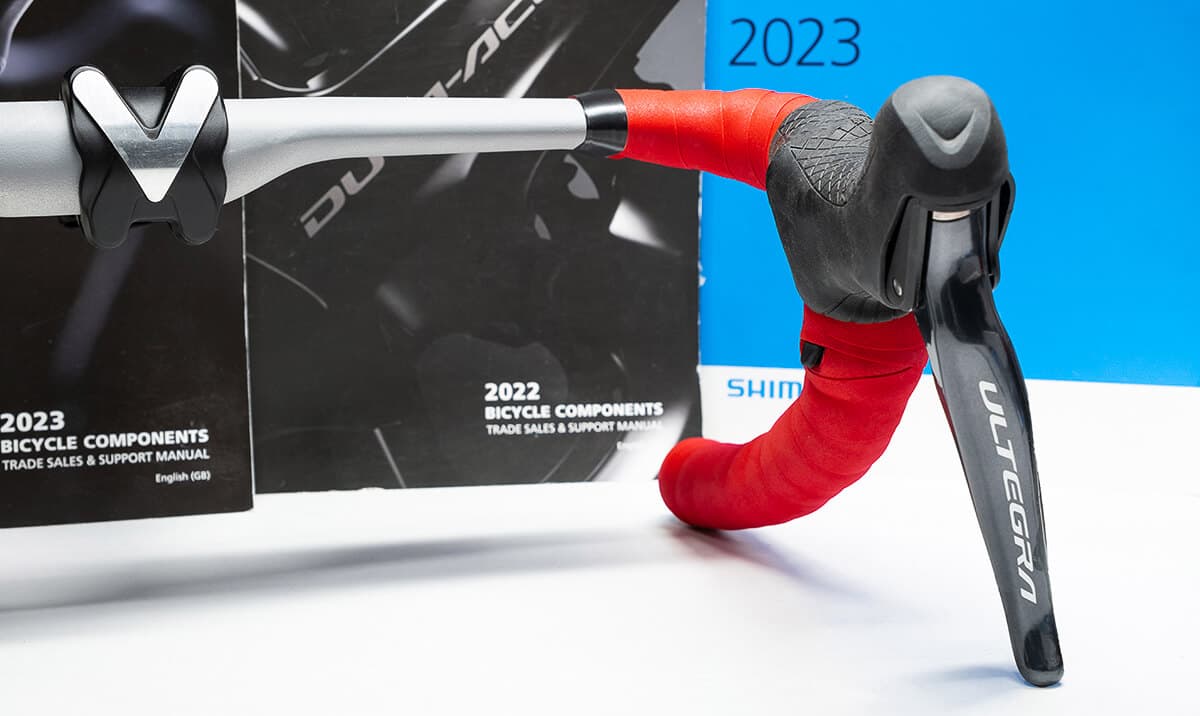 Shifter button through handlebar tape